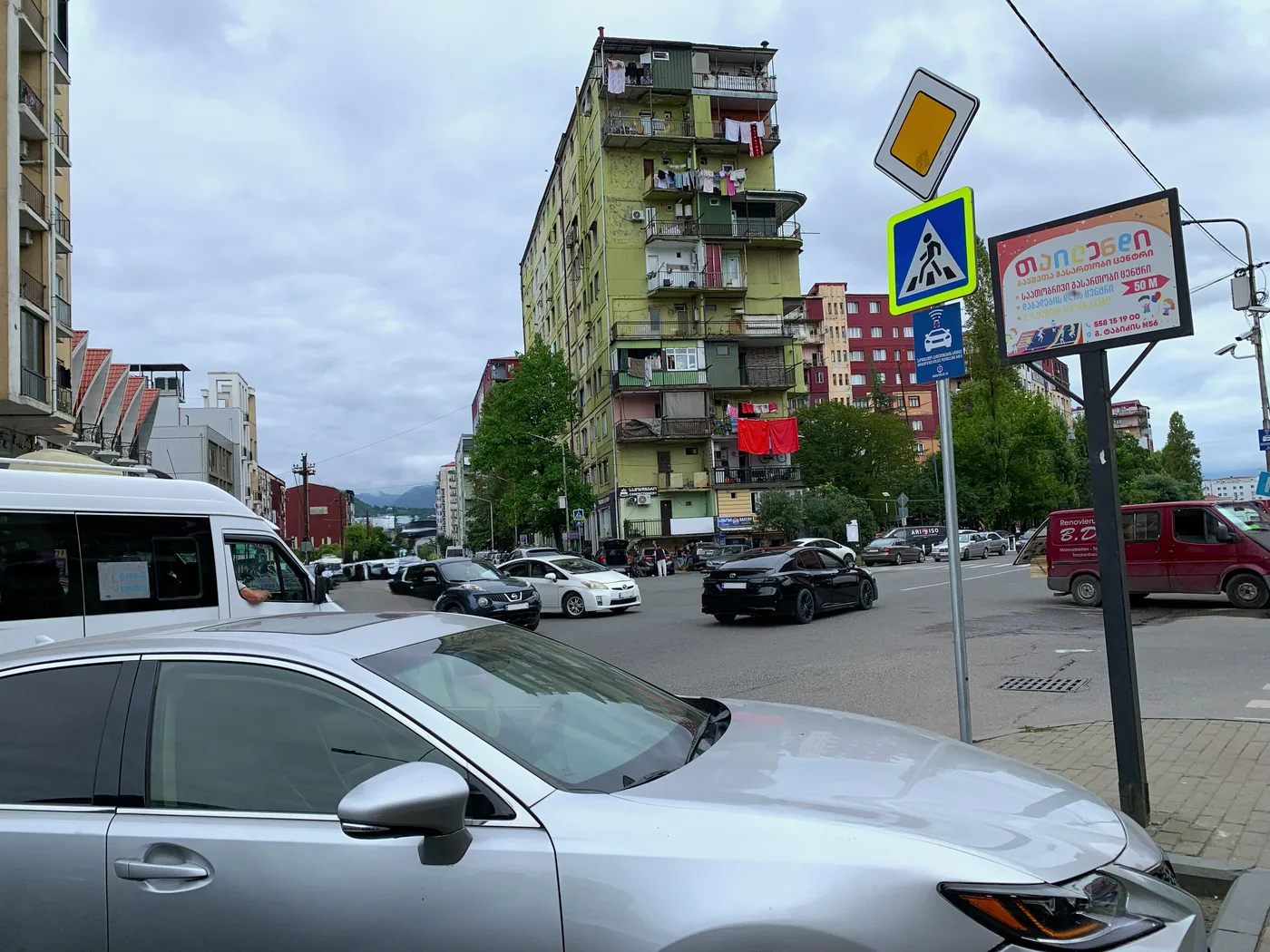 A nine-storey building with glazed balconies on a street in the Agmashenebeli district