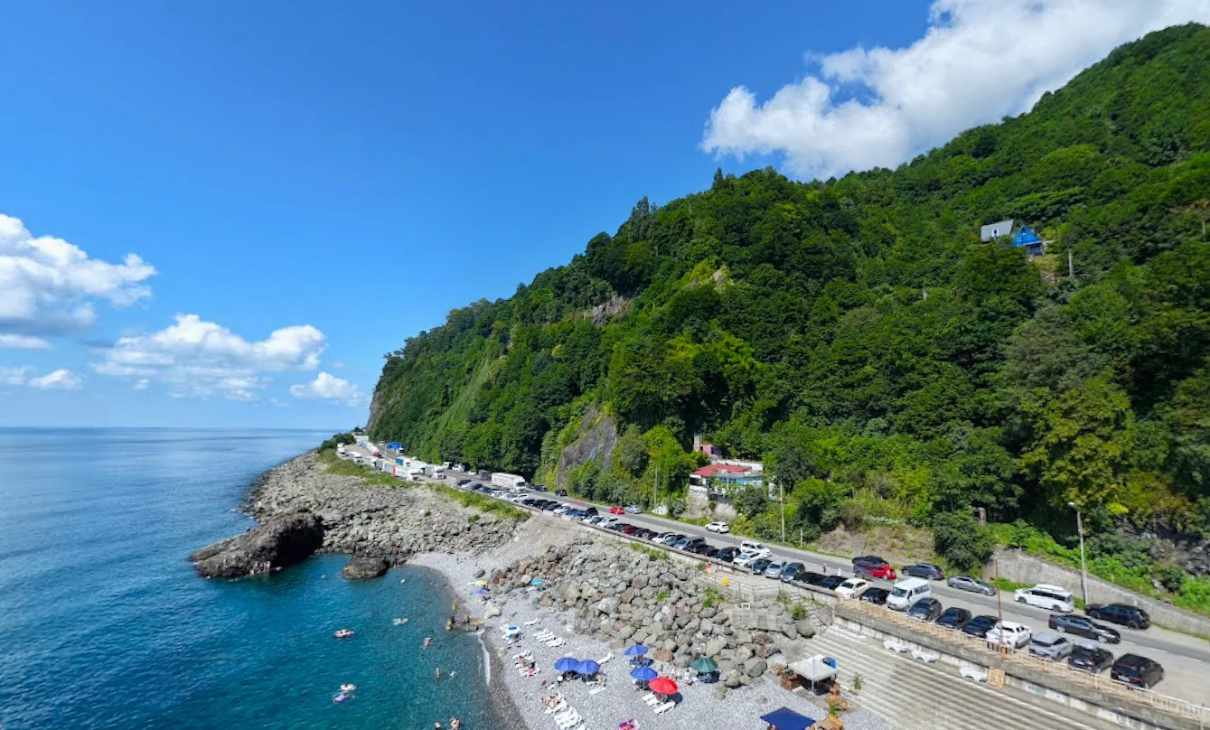 Clean sea, pebble beach and green mountains in Gonio near Batumi
